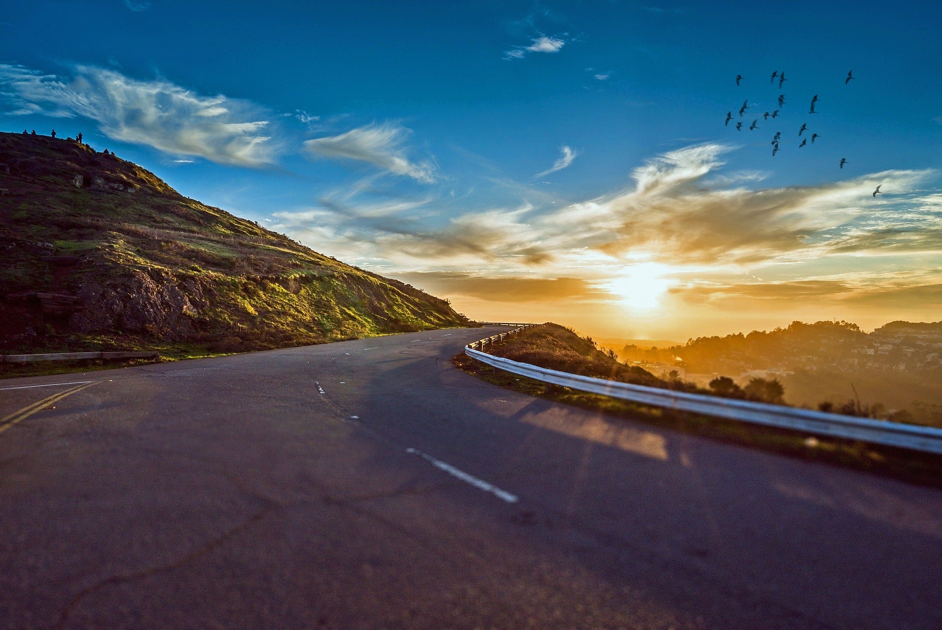 Picture of an empty winding road with sunset